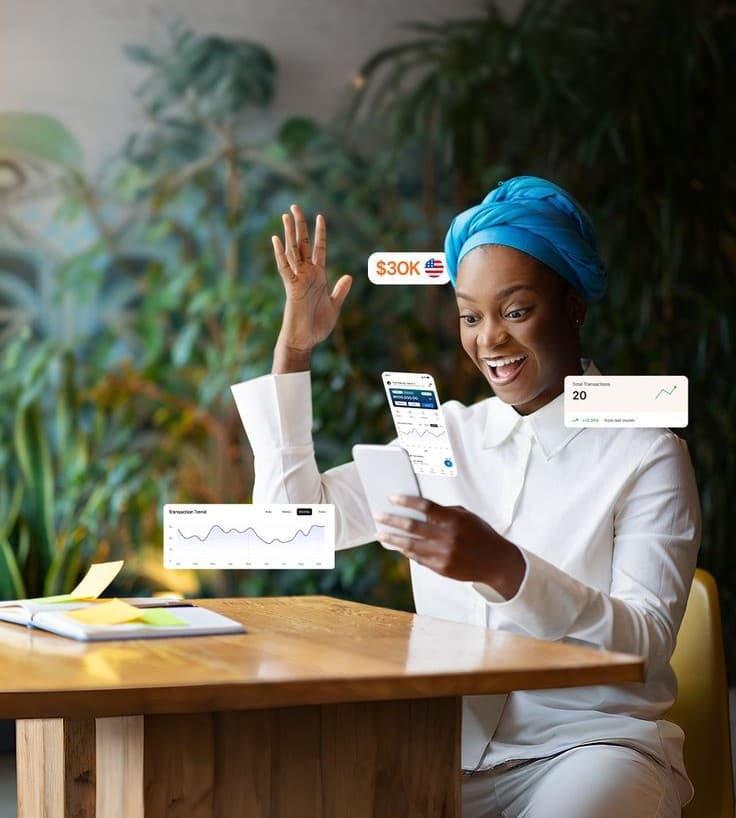 An HI Investments Africa member reviewing her portfolio on her phone
